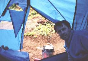 We managed to cook a dehydrated camp meal under one of the two tent vestibules, while it rained. Fire marshalls will note that the vestibule door is open for safety reasons. Cooking a home-made dehydrated camp meal at Indian Bar, in our tent. (Wonderland Trail, Mt. Rainier National Park)